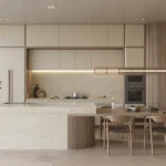 Caesarstone ICON 8251 Taj Whisper Kitchen in modern kitchen with marble island, built-in appliances, wooden dining table, chairs, and decorative plants.