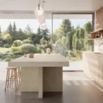 Caesarstone ICON 8252 Sedara in Modern kitchen with large island, wooden stools, minimalist cabinetry, and garden view through glass doors.